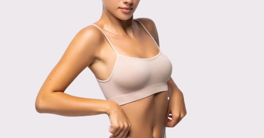 Close-up of a woman’s breast wearing a nude bra (model)