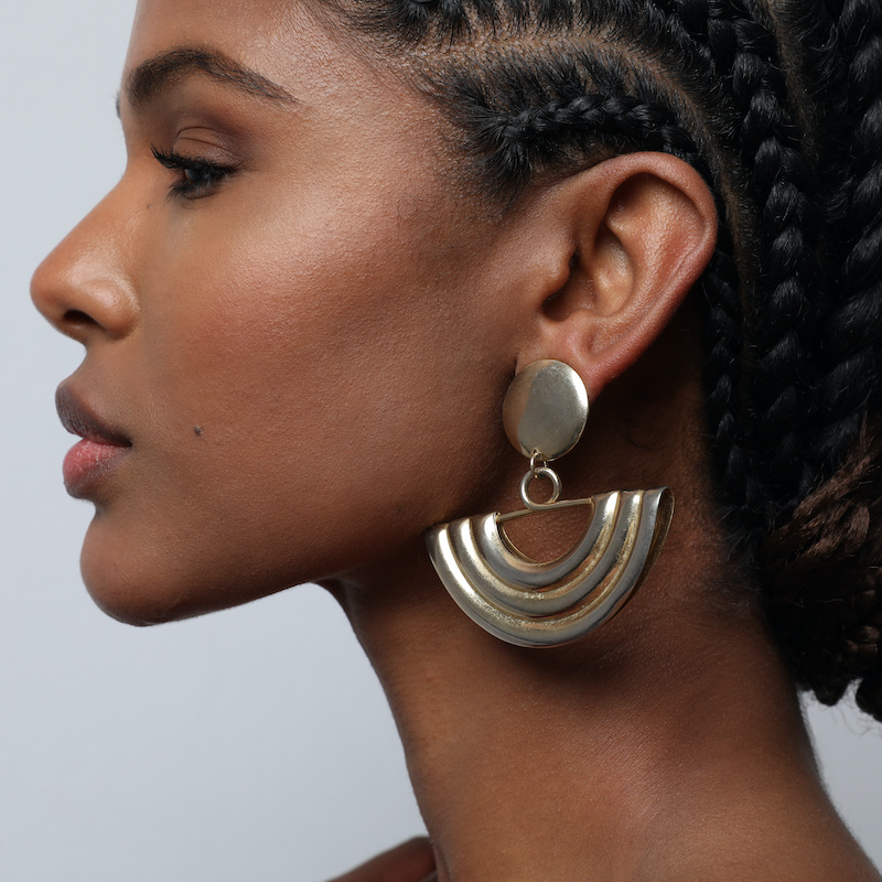 close up of womans earlobe with glamorous earrings