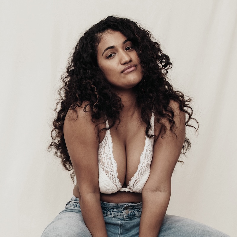 happy young woman in bra and jeans
